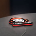 La Casa De Papel LED lightbox lying flat on a desk with red glow