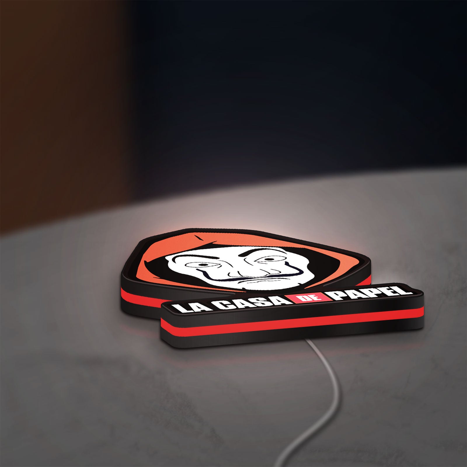 La Casa De Papel LED lightbox lying flat on a desk with red glow