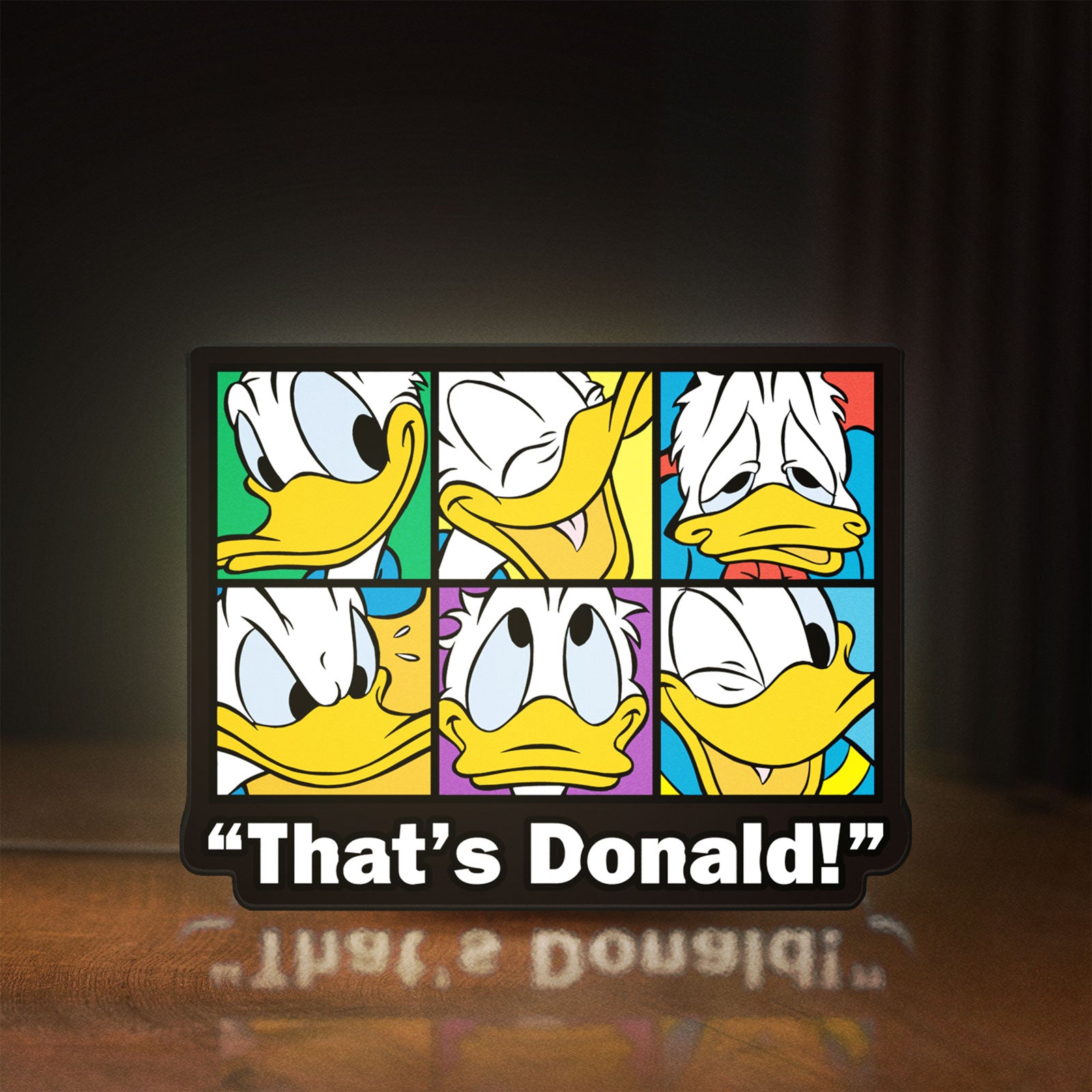 Front view of That's Donald LED lightbox sign glowing on a wooden desk