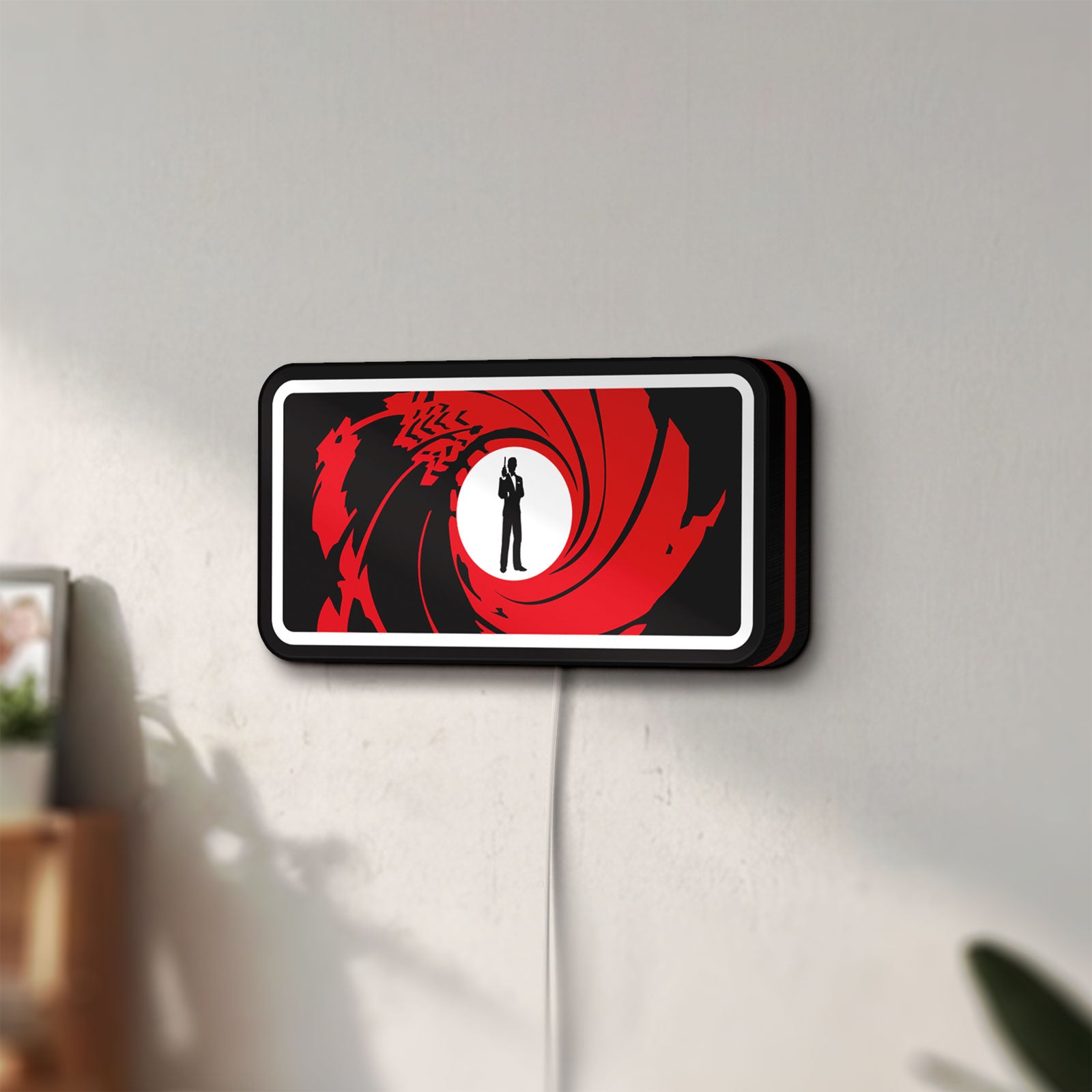 Unlit James Bond 007 LED lightbox mounted on a wall in daylight