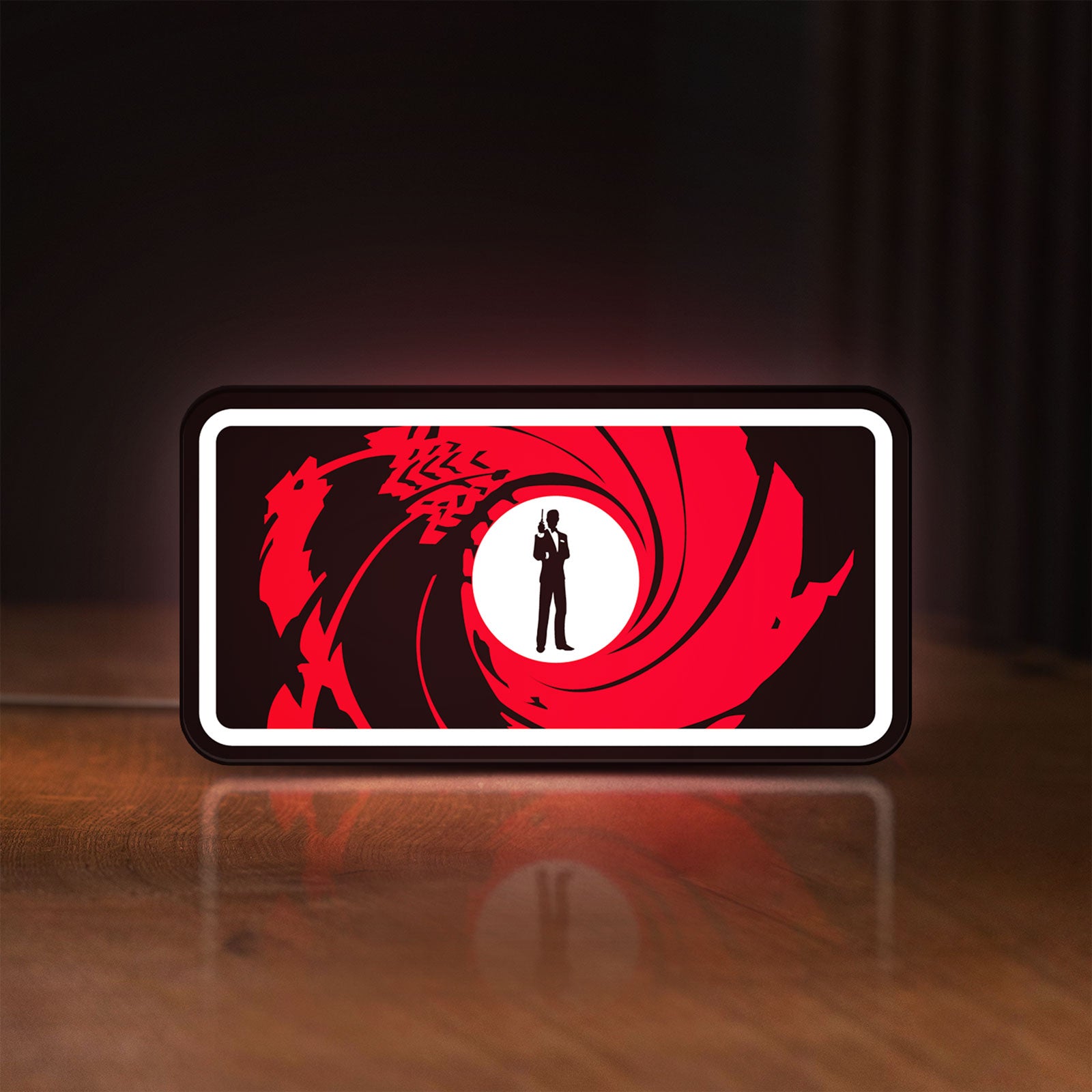 Front view of James Bond 007 LED lightbox sign glowing on a wooden desk