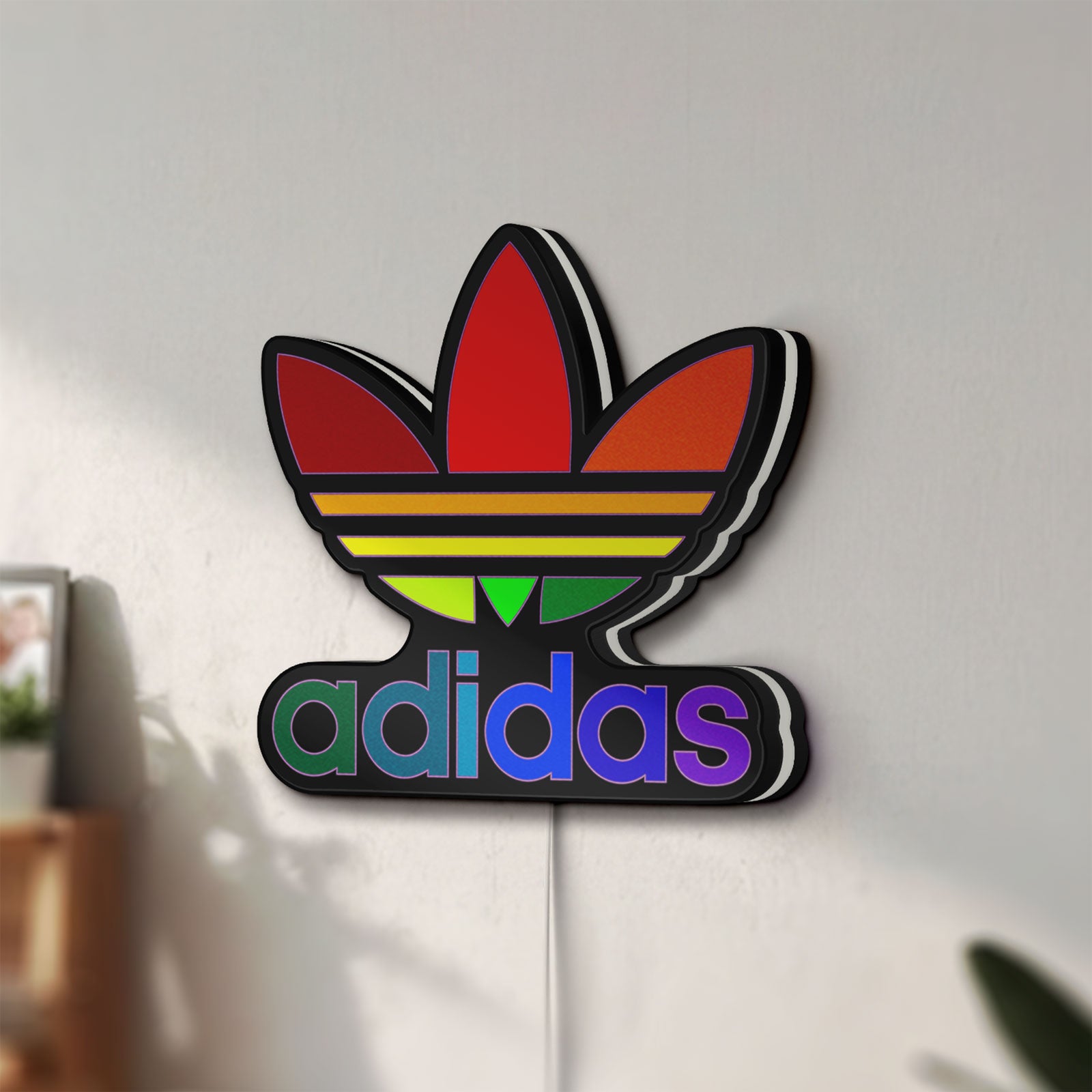 Unlit Adidas LED lightbox mounted on a wall in daylight