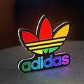 Adidas LED lightbox standing on a desk from an angled side view with white glow