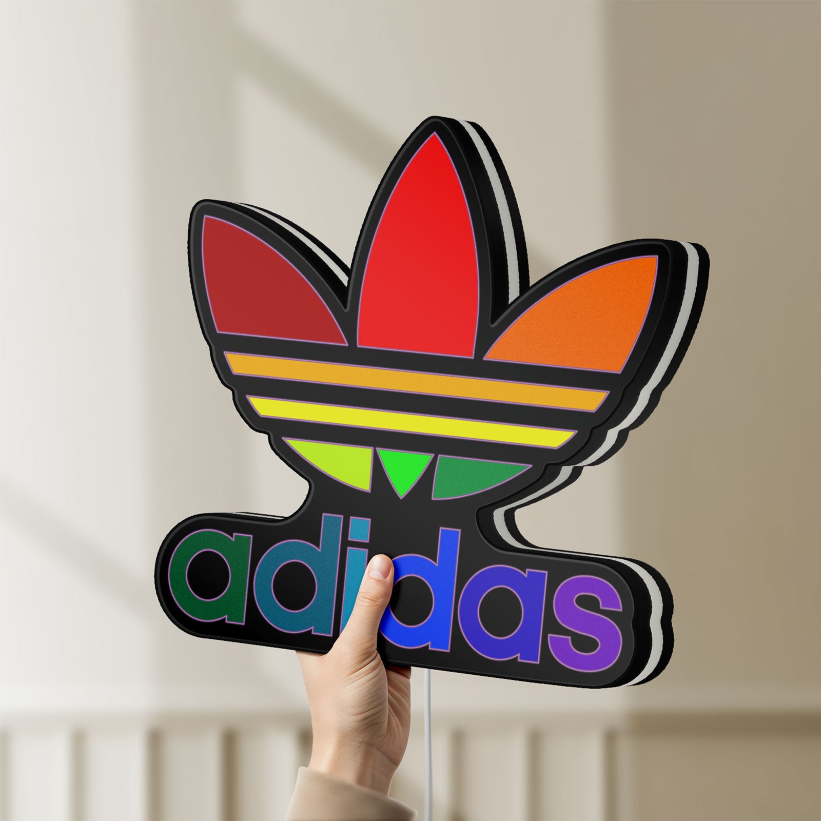 Unlit Adidas LED lightbox held by hand to show size and details