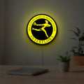 Interflora Mercury Man LED lightbox hanging on a room wall with soft yellow light