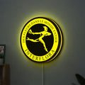 Interflora Mercury Man LED lightbox hanging on a wall with yellow glow
