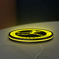 Interflora Mercury Man LED lightbox lying flat on a desk with yellow glow