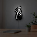 Death Metal LED lightbox hanging on a room wall with soft white light