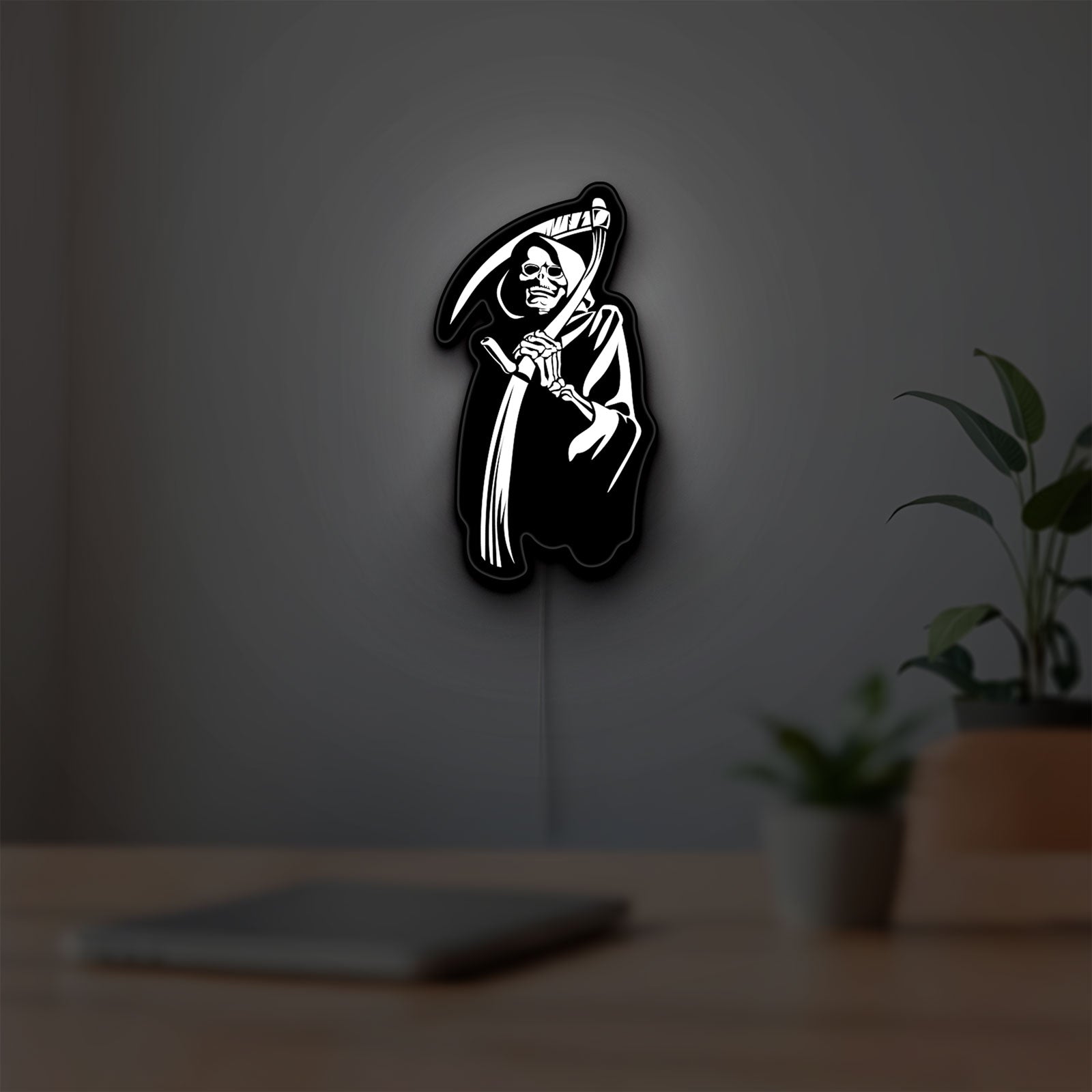 Death Metal LED lightbox hanging on a room wall with soft white light