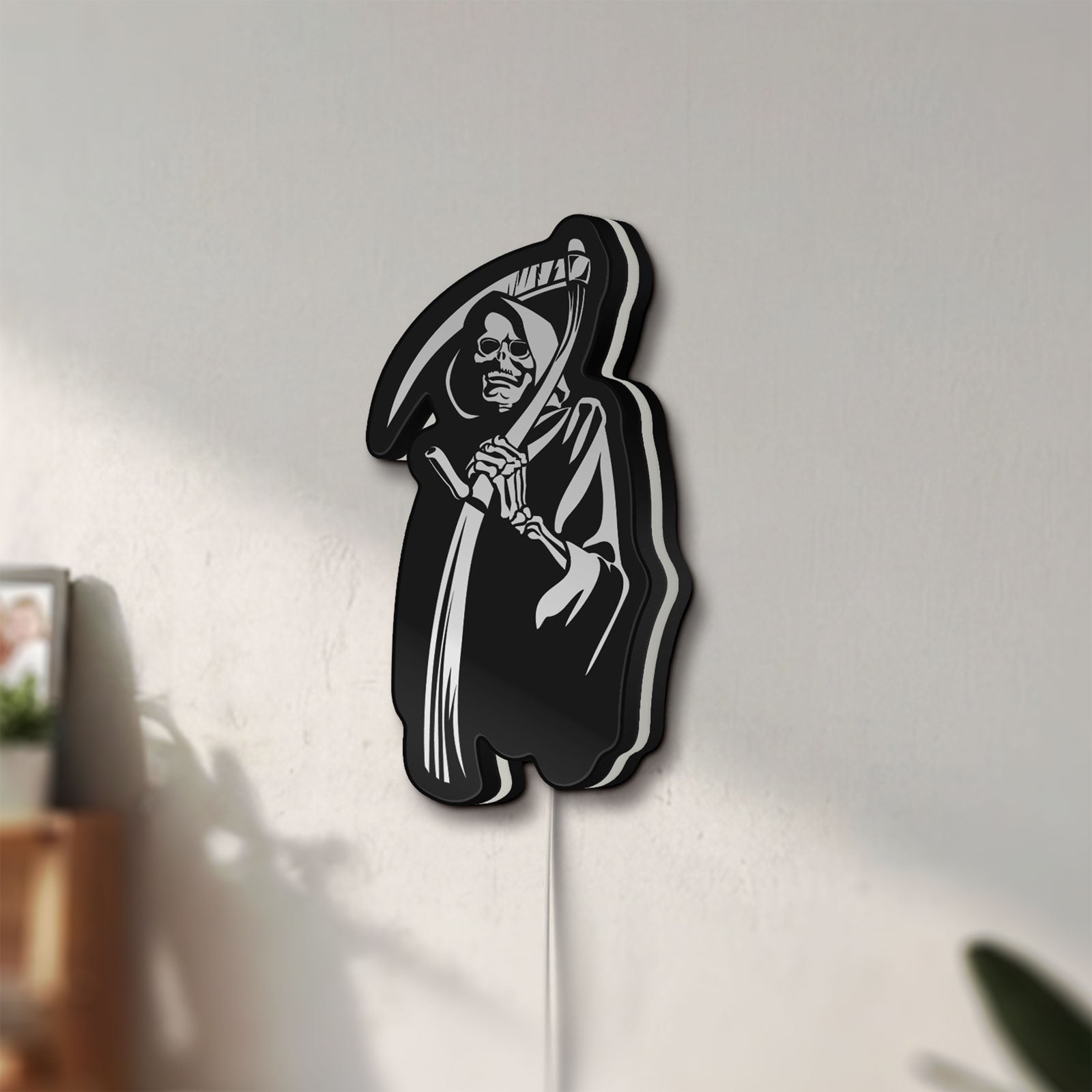 Unlit Death Metal LED lightbox mounted on a wall in daylight