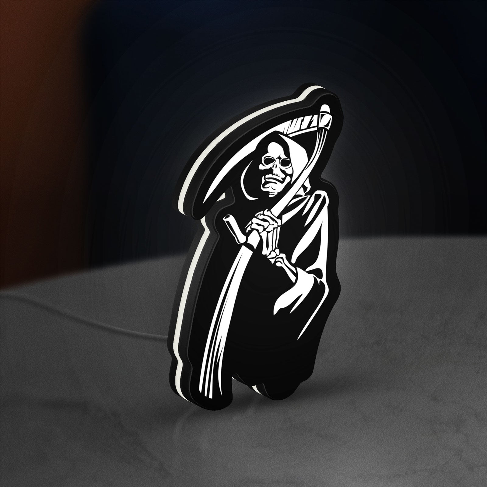 Death Metal LED lightbox standing on a desk from an angled side view with white glow