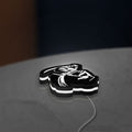 Death Metal LED lightbox lying flat on a desk with white glow