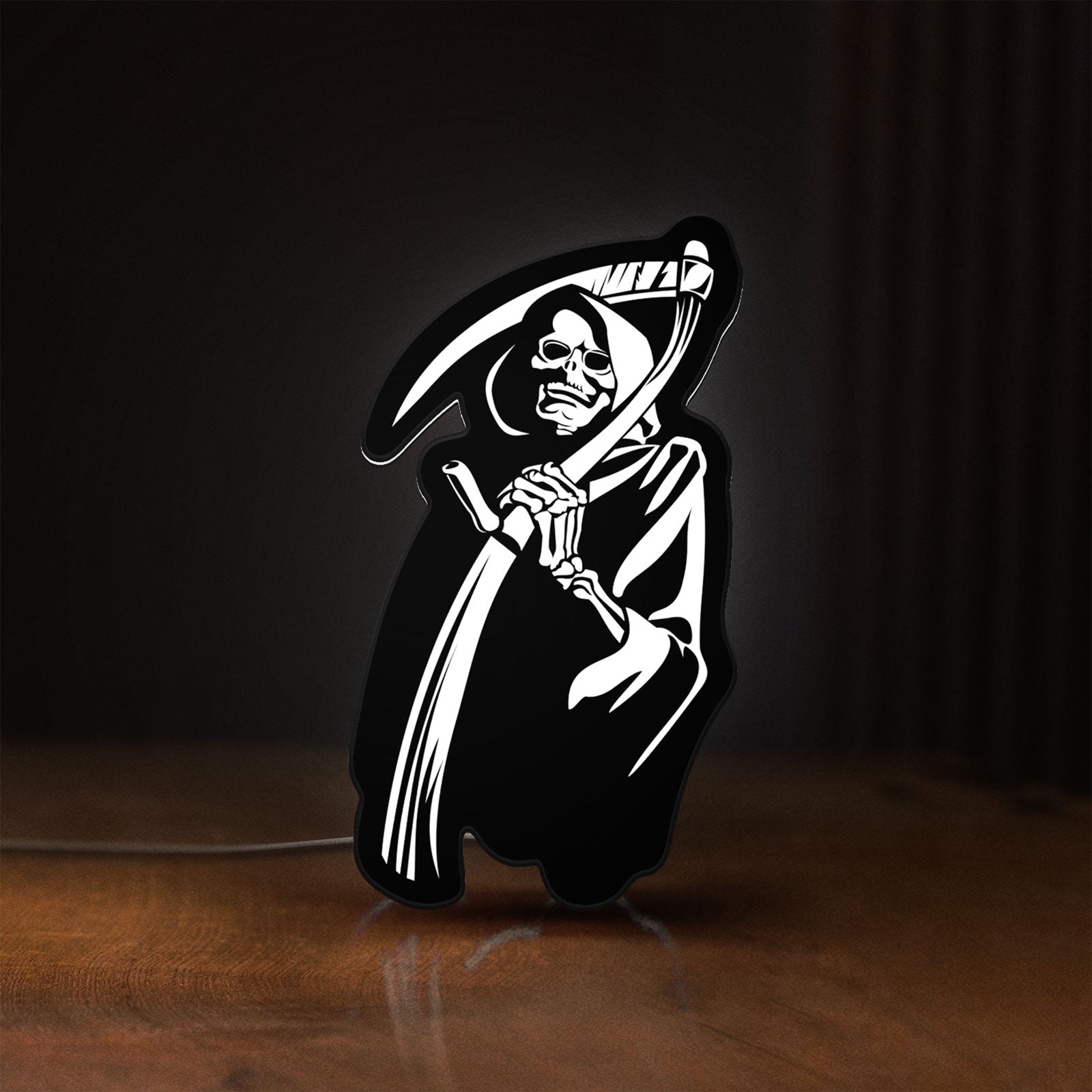 Front view of Death Metal LED lightbox sign glowing on a wooden desk