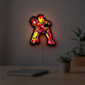 Iron Man LED lightbox hanging on a room wall with soft yellow light
