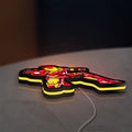 Iron Man LED lightbox lying flat on a desk with yellow glow