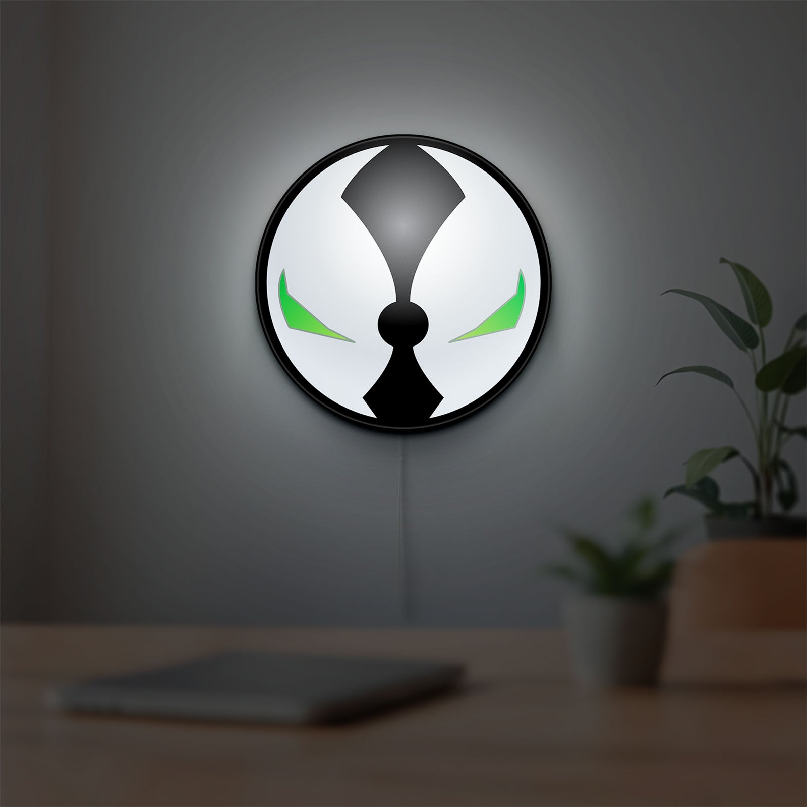 Spawn Mask LED lightbox hanging on a room wall with soft white light