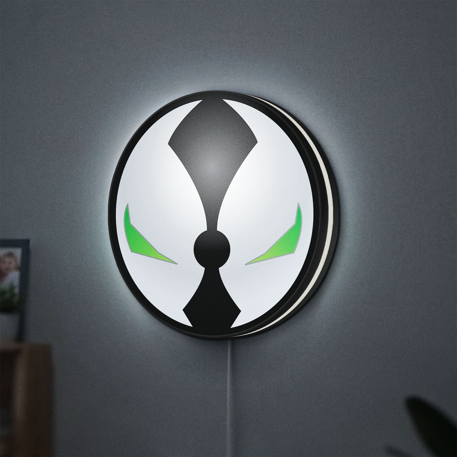 Spawn Mask LED lightbox hanging on a wall with white glow
