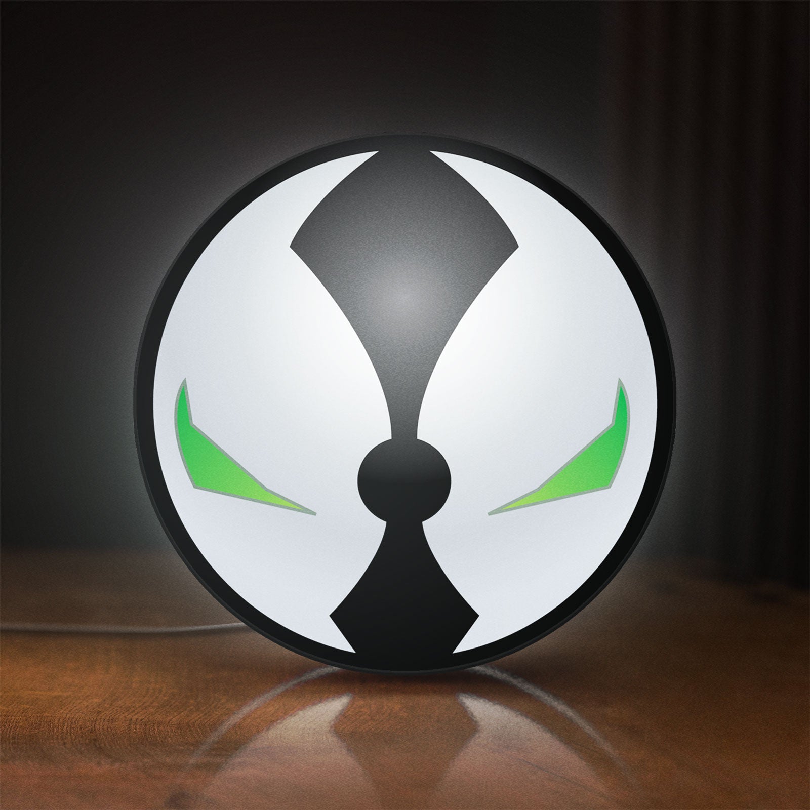 Front view of Spawn Mask LED lightbox sign glowing on a wooden desk
