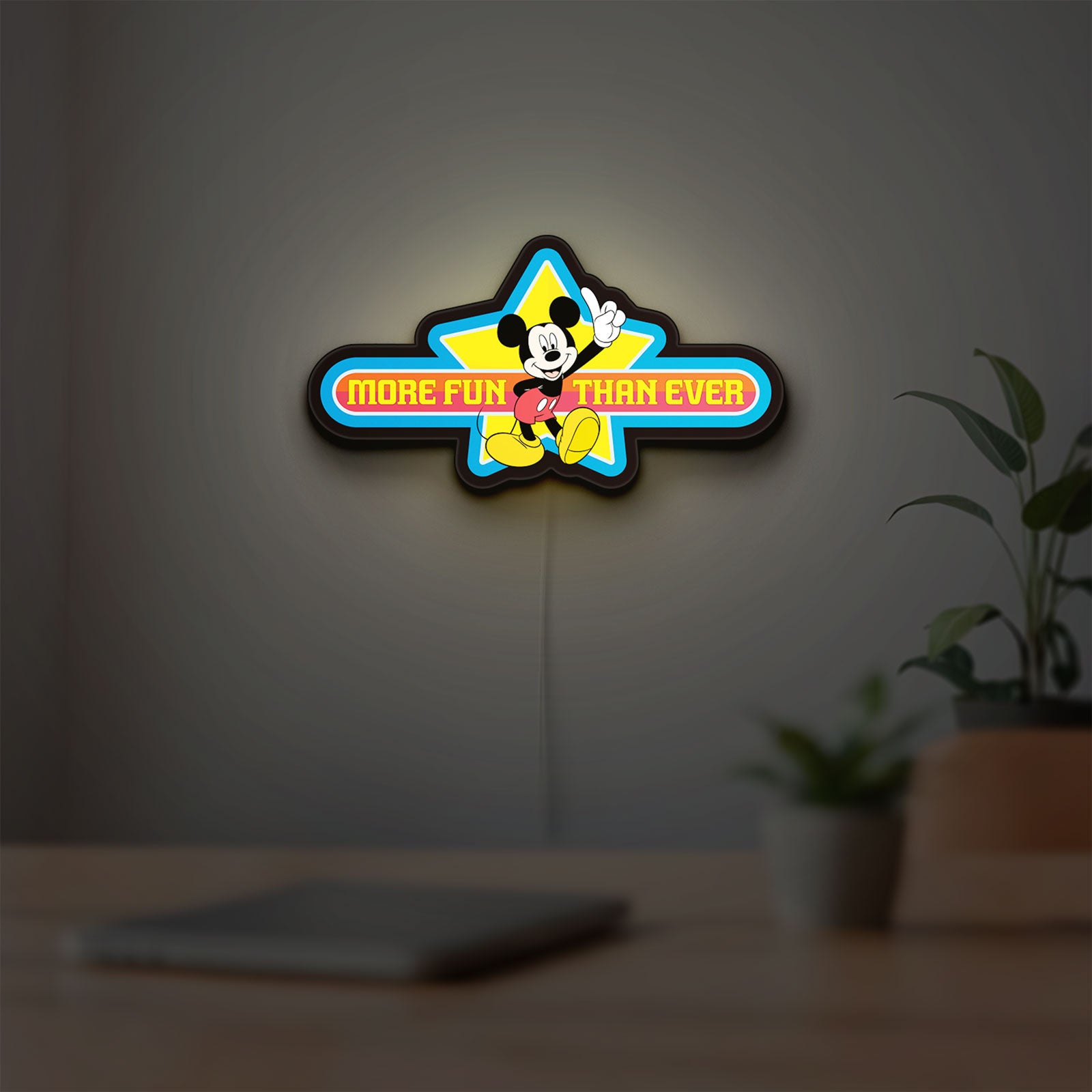 Mickey Mouse LED lightbox hanging on a room wall with soft blue light