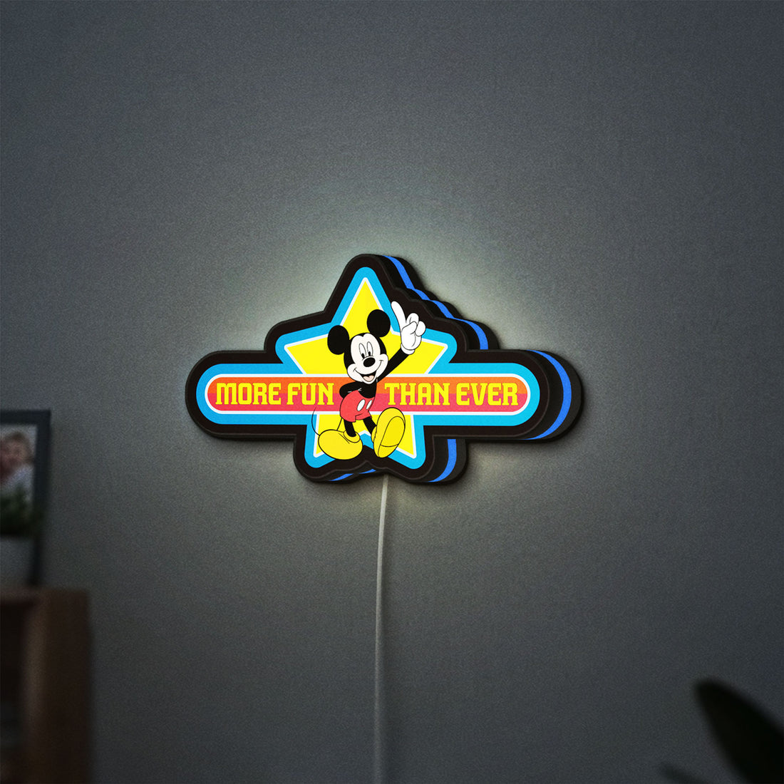 Mickey Mouse LED lightbox hanging on a wall with blue glow