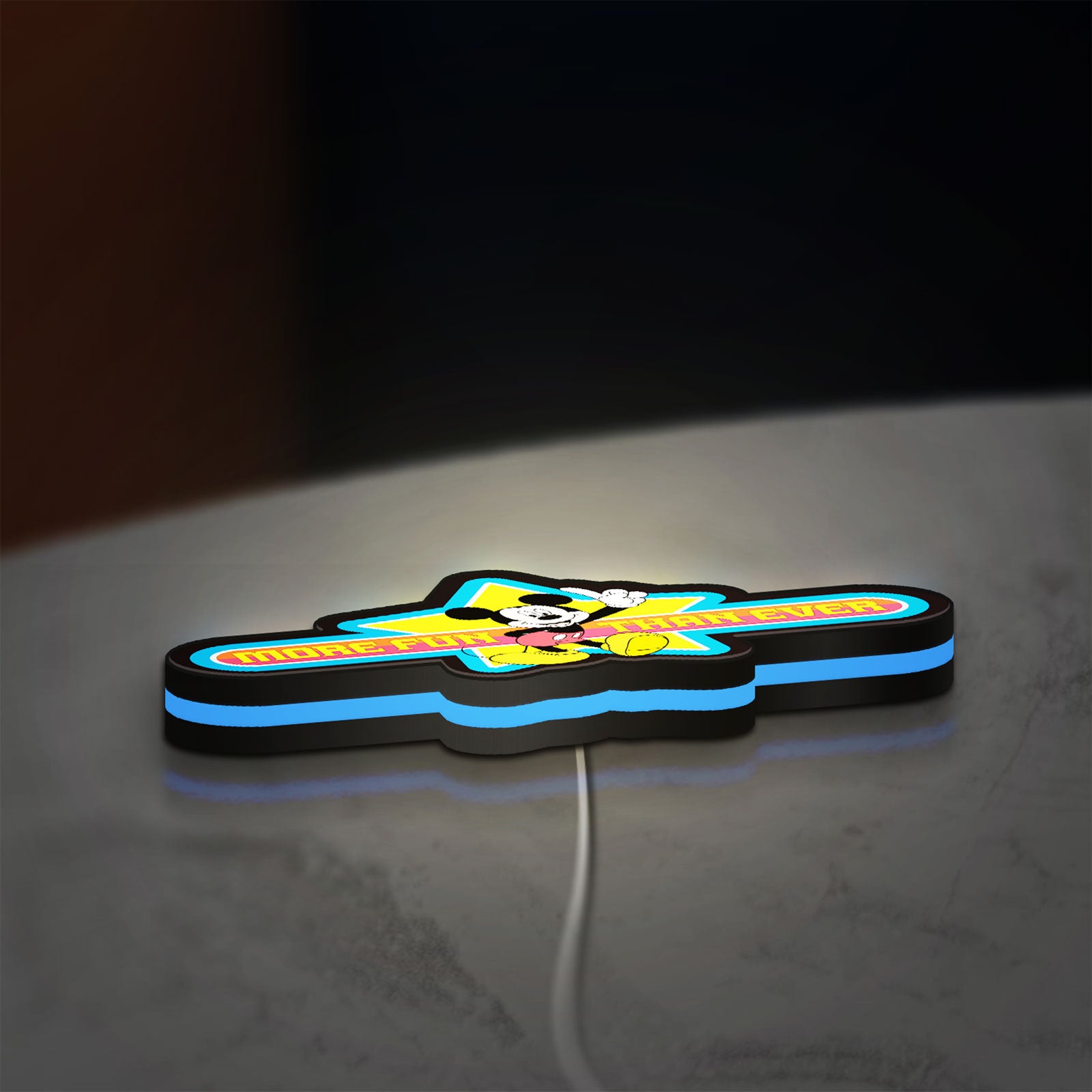 Mickey Mouse LED lightbox lying flat on a desk with blue glow
