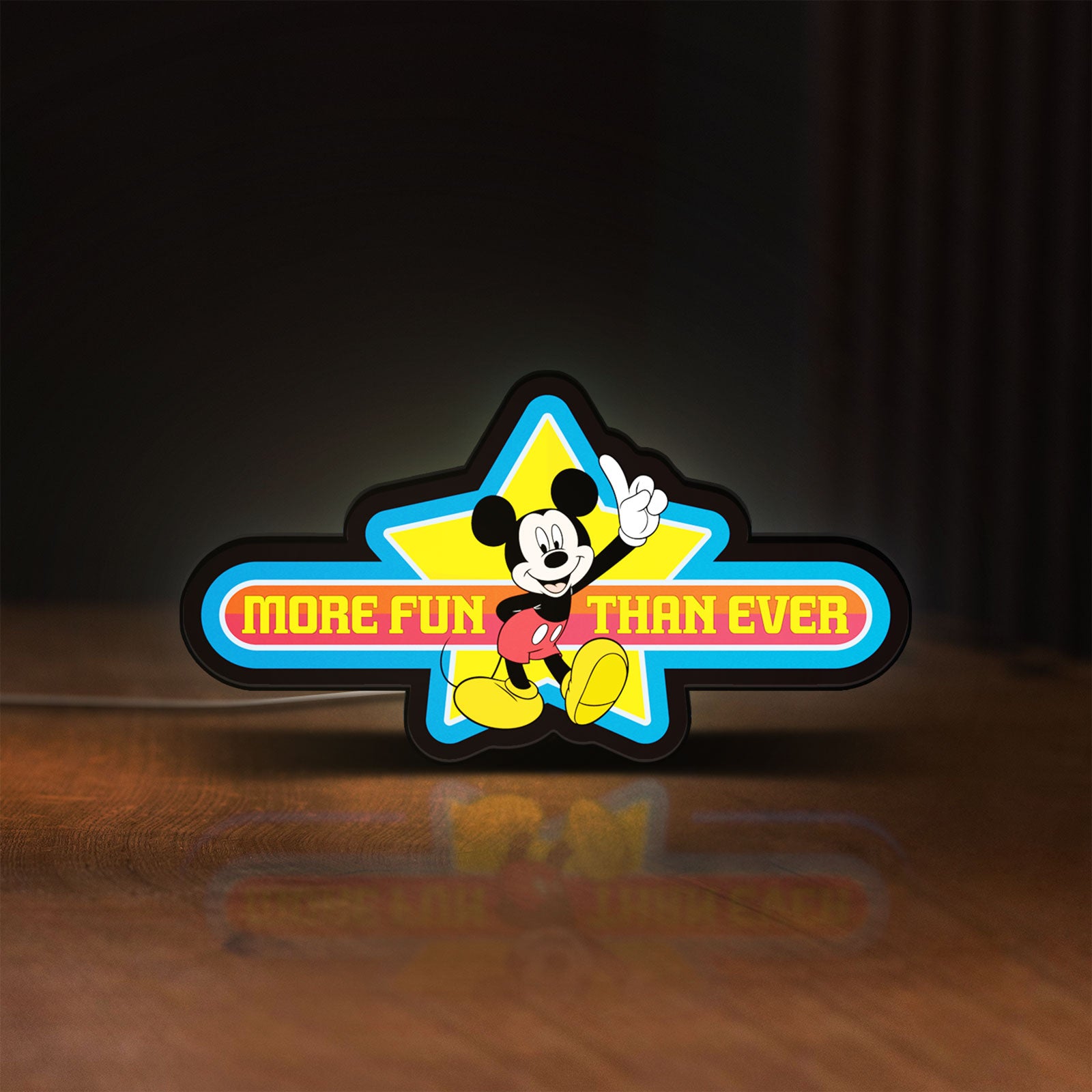 Front view of Mickey Mouse LED lightbox sign glowing on a wooden desk