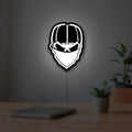 Skull Gang LED lightbox hanging on a room wall with soft white light
