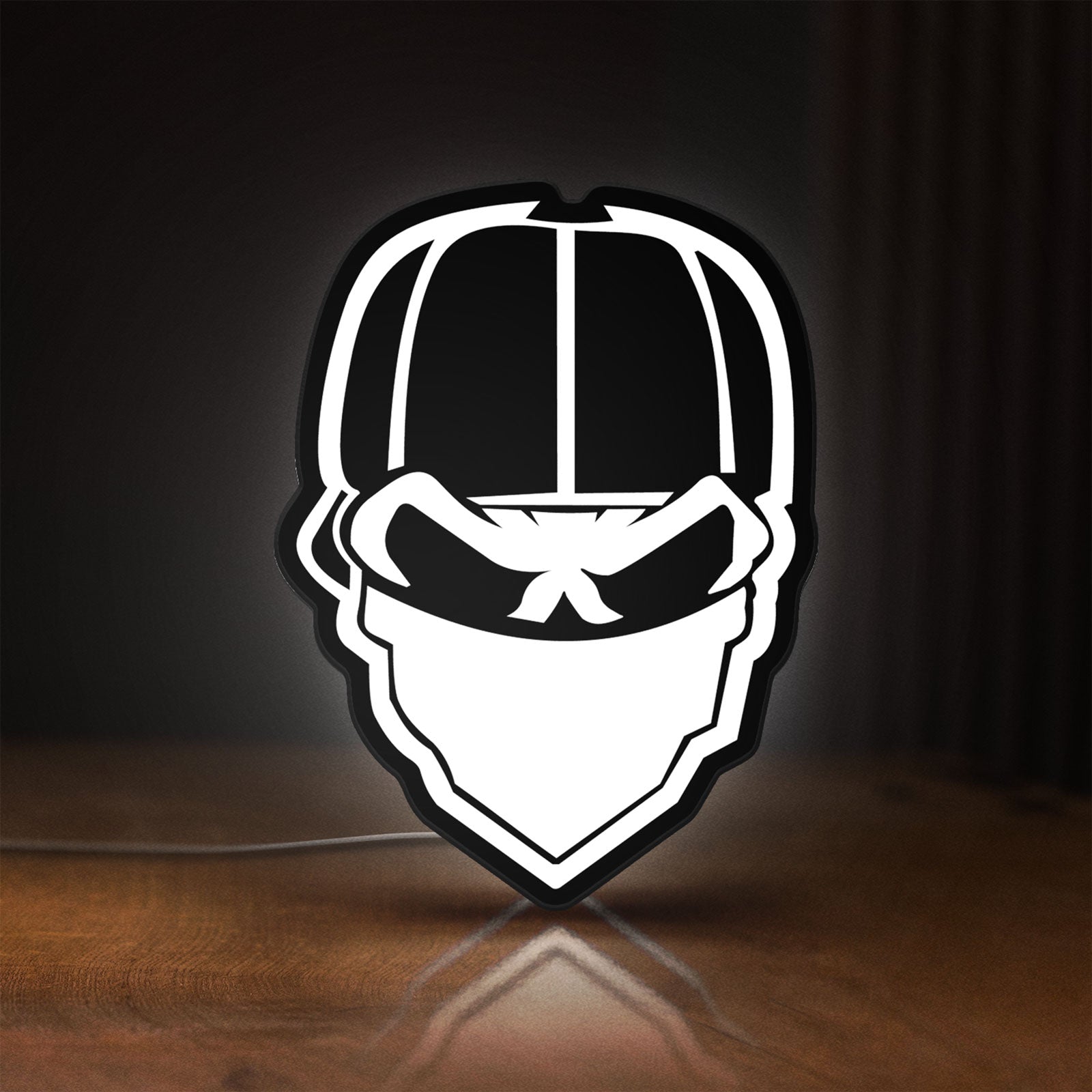 Front view of Skull Gang LED lightbox sign glowing on a wooden desk