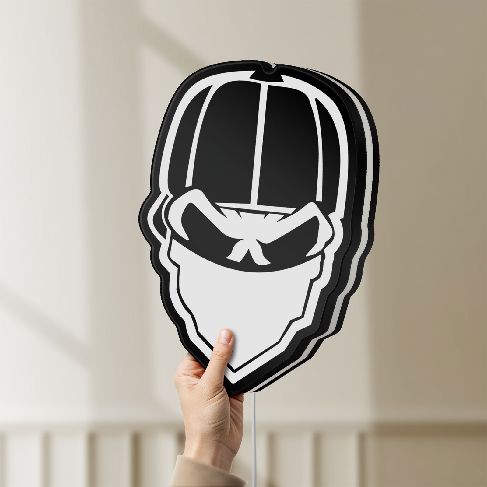 Unlit Skull Gang LED lightbox held by hand to show size and details