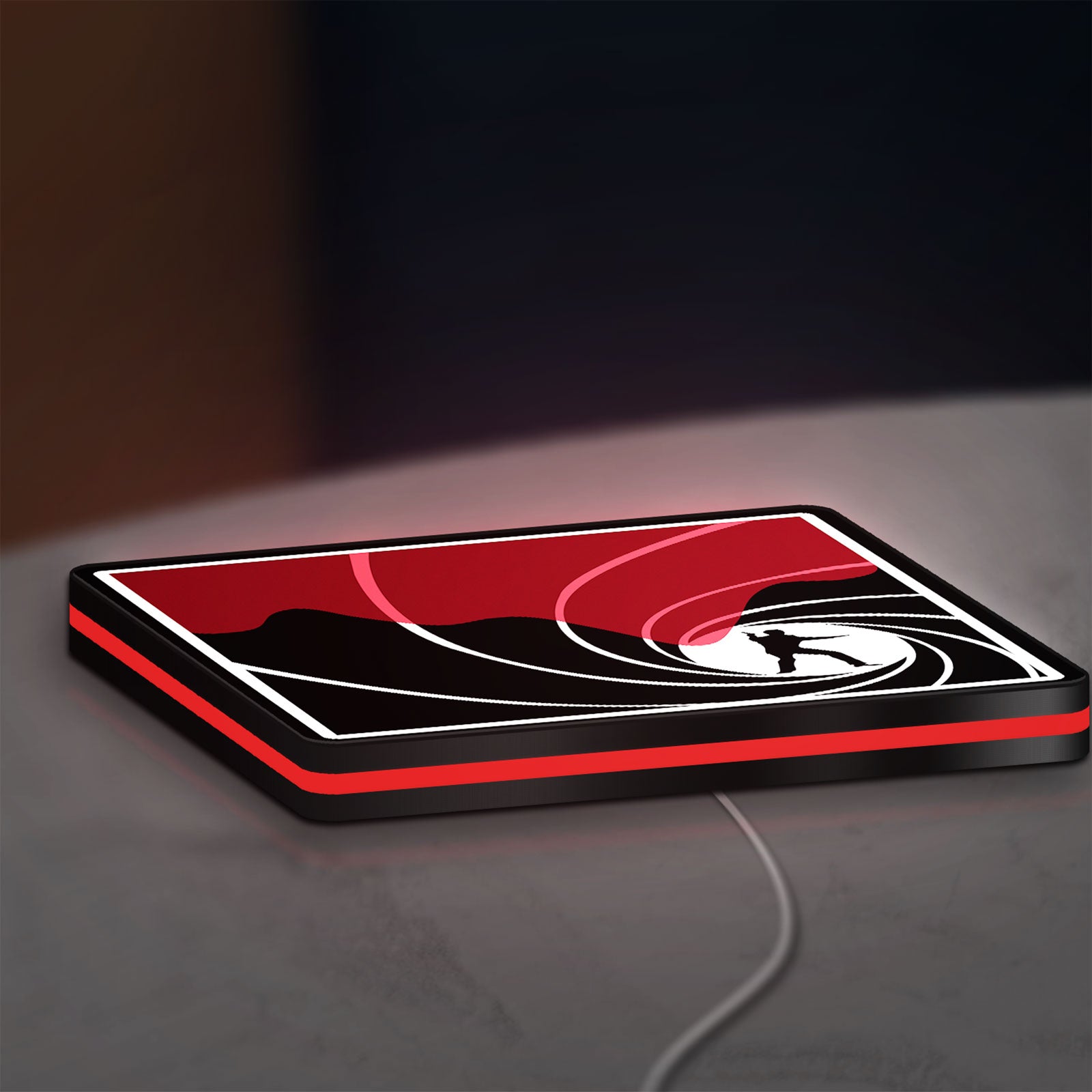 James Bond 007 LED lightbox lying flat on a desk with red glow