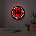 Custom LED Logo Sign LED lightbox hanging on a room wall with soft red light