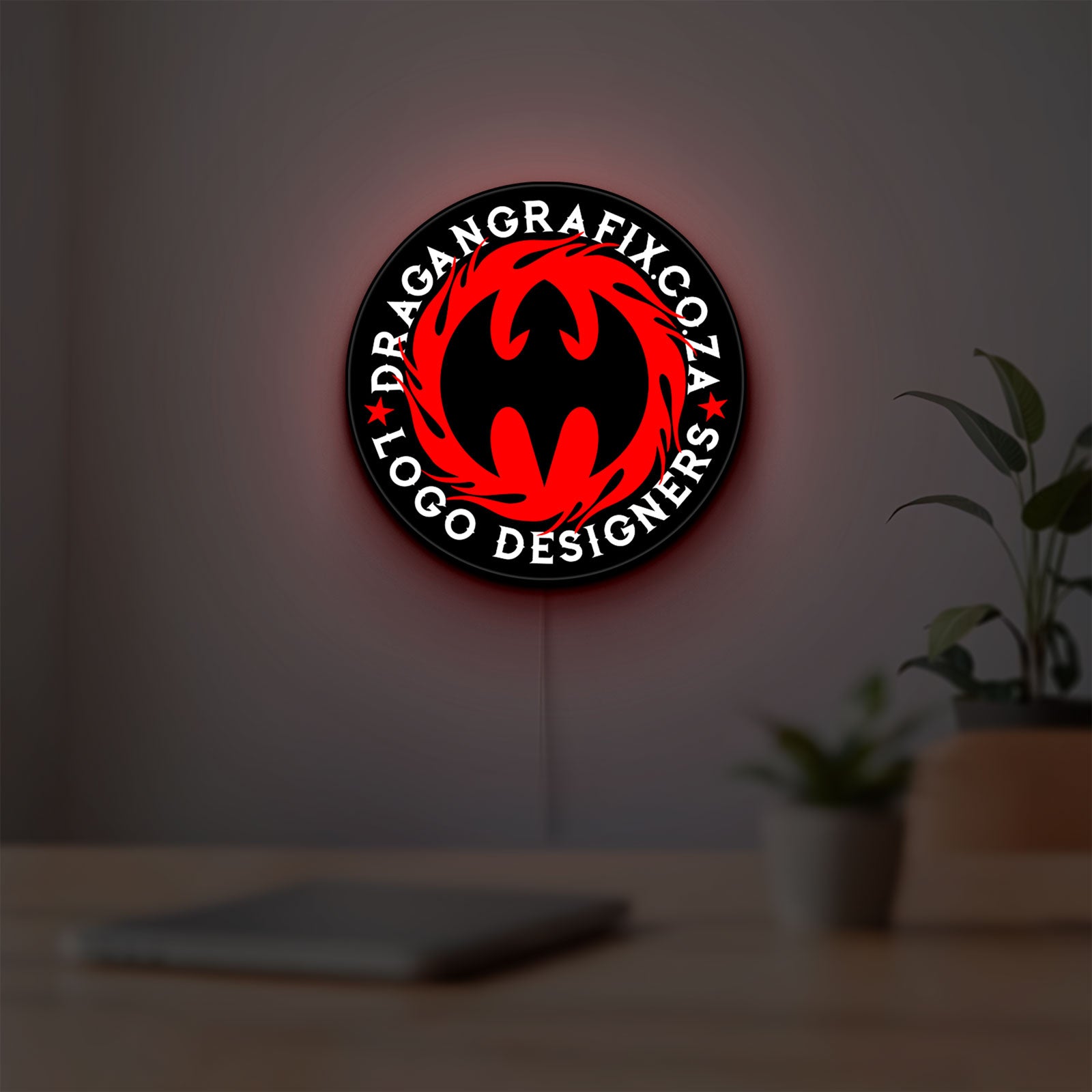 Custom LED Logo Sign LED lightbox hanging on a room wall with soft red light