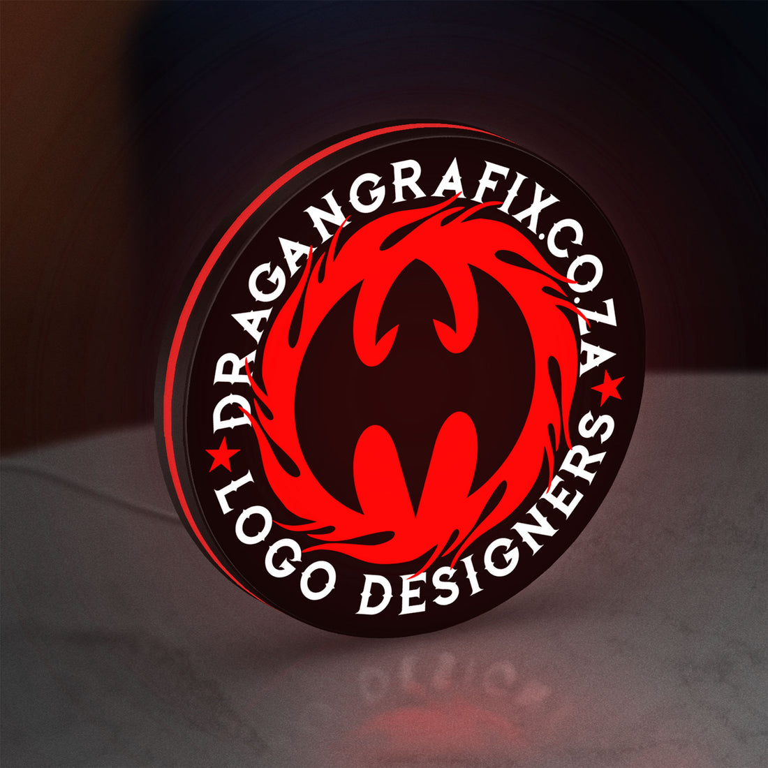 Custom LED Logo Sign LED lightbox hanging on a wall with red glow