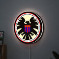 S.H.I.E.L.D. LED lightbox hanging on a wall with white glow