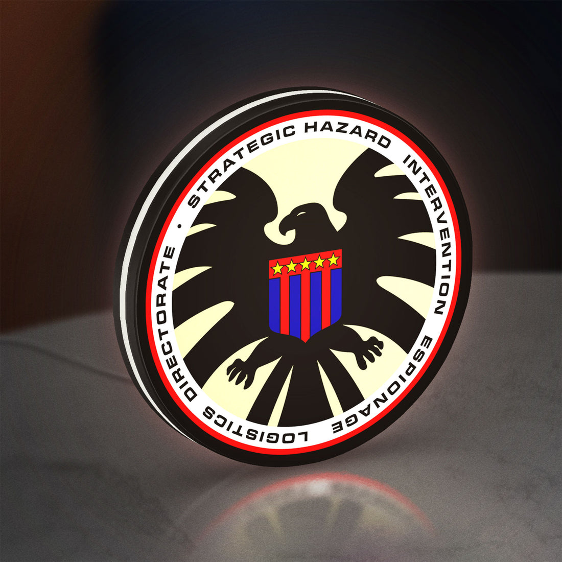 S.H.I.E.L.D. LED lightbox hanging on a wall with white glow
