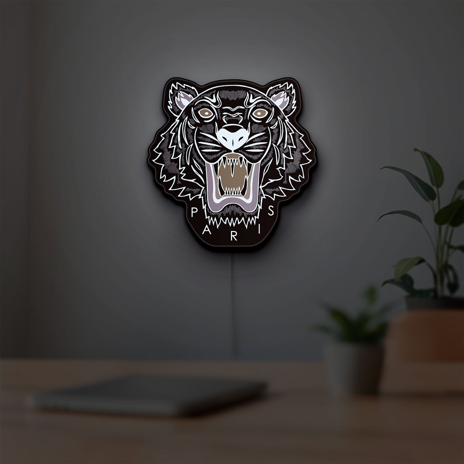 KENZO PARIS LED lightbox hanging on a room wall with soft white light