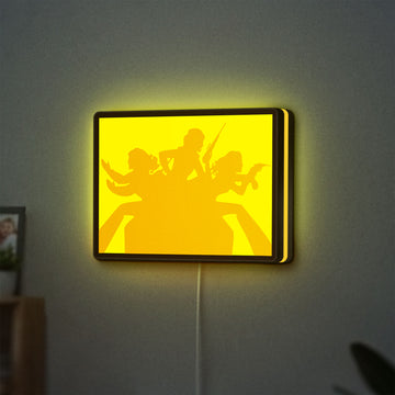 Charlie's Angels LED lightbox hanging on a wall with yellow glow