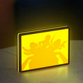 Charlie's Angels LED lightbox standing on a desk from an angled side view with yellow glow