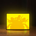 Front view of Charlie's Angels LED lightbox sign glowing on a wooden desk
