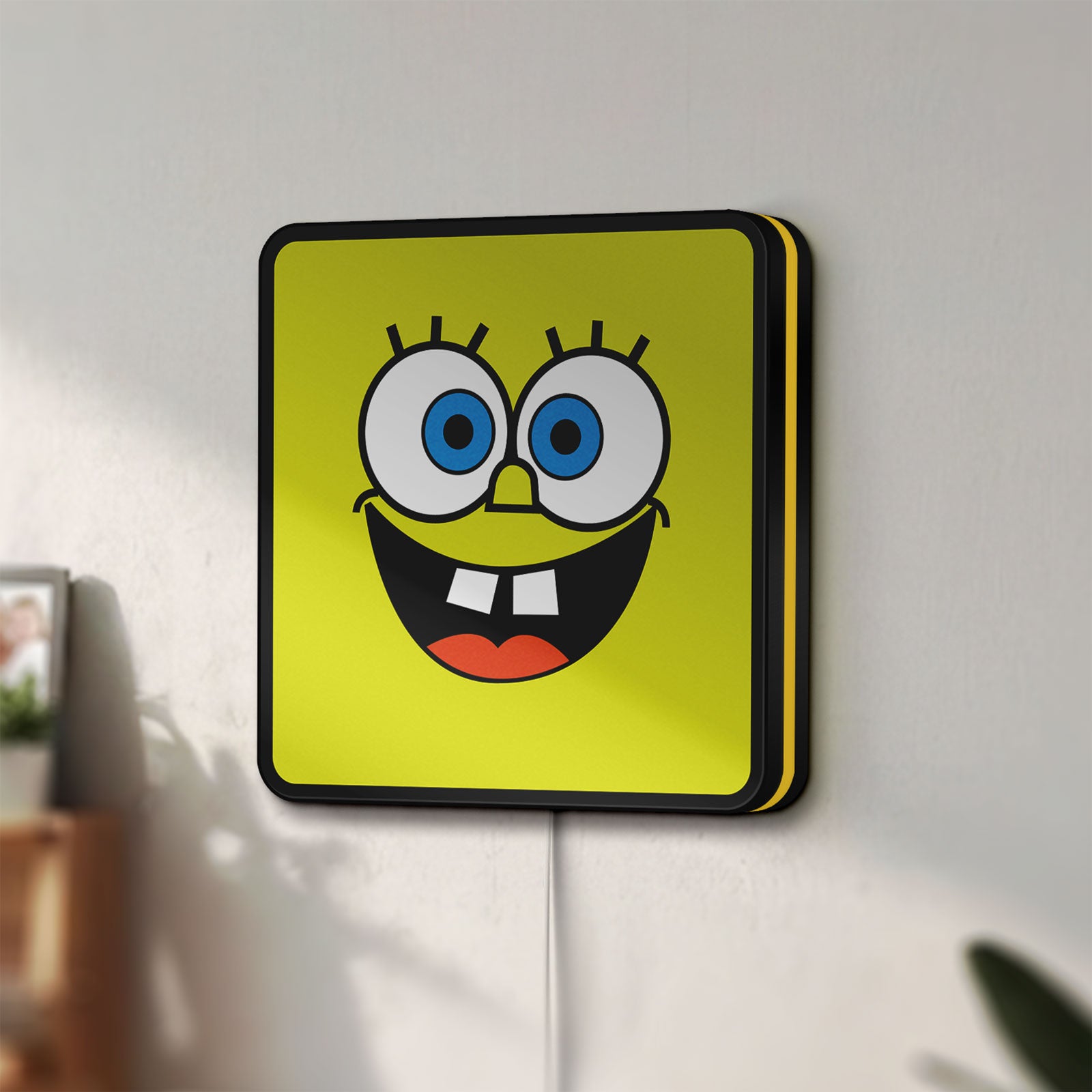 Unlit Spongebob Squarepants LED lightbox mounted on a wall in daylight