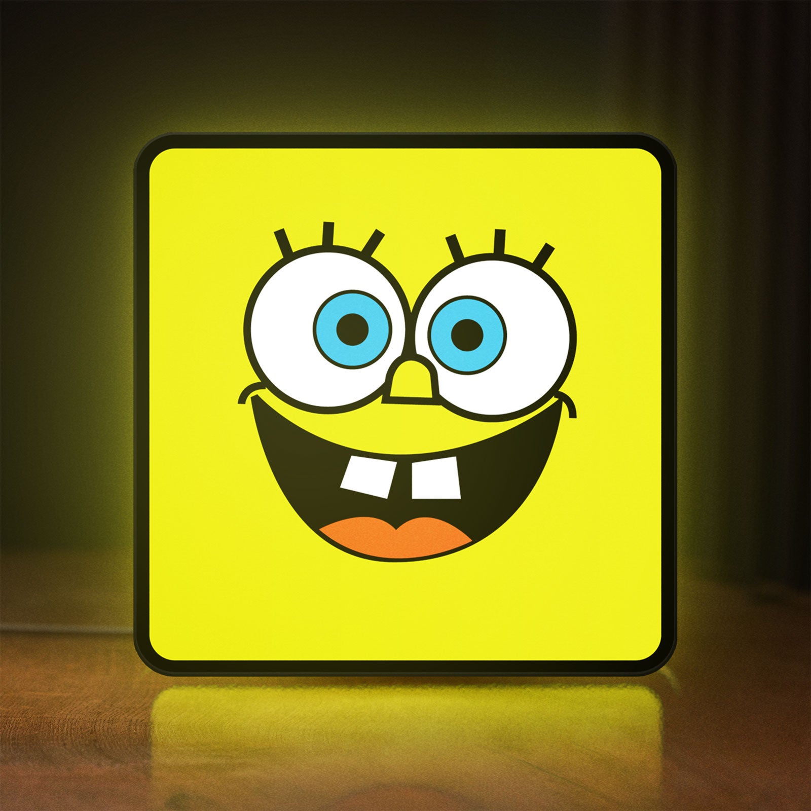 Front view of Spongebob Squarepants LED lightbox sign glowing on a wooden desk