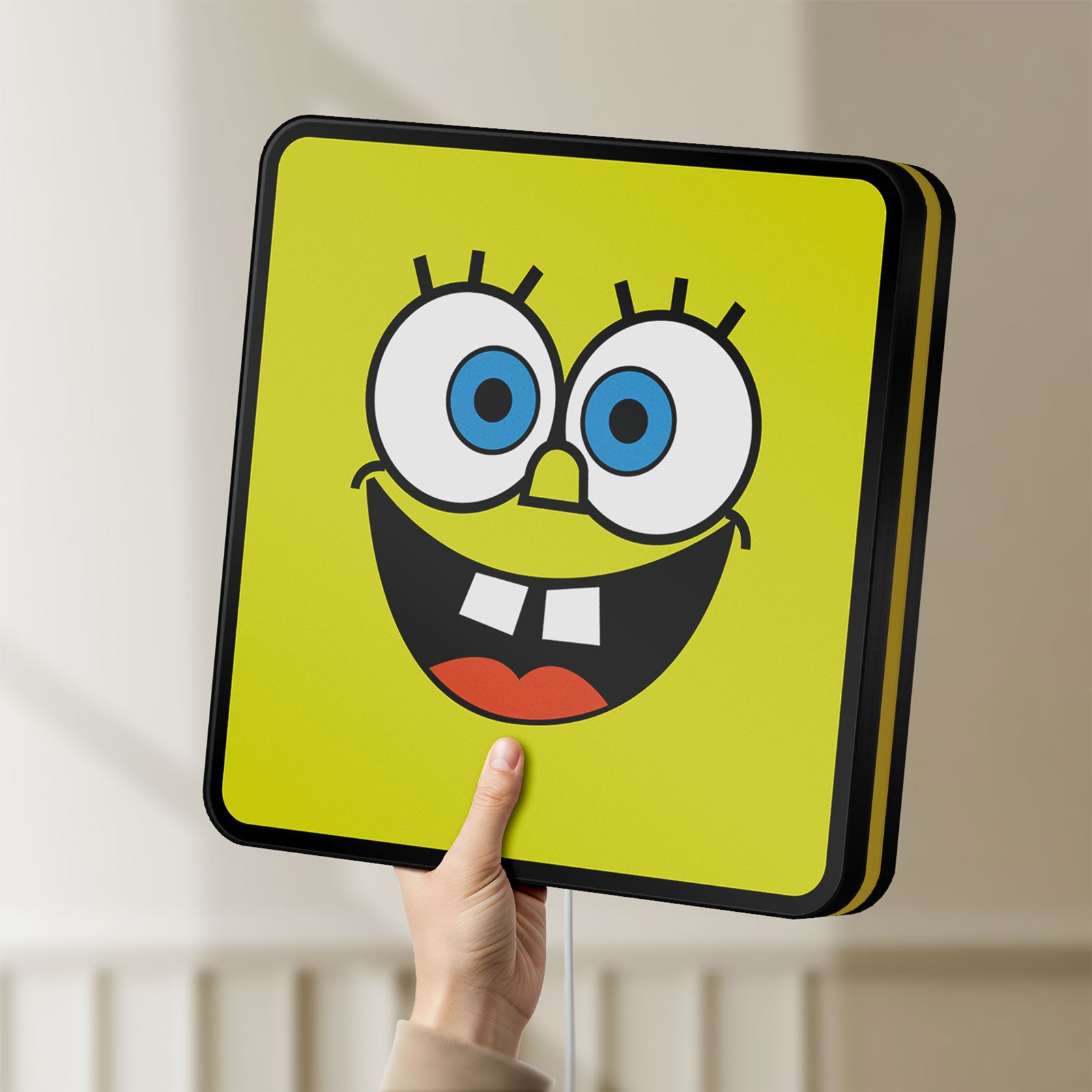 Unlit Spongebob Squarepants LED lightbox held by hand to show size and details