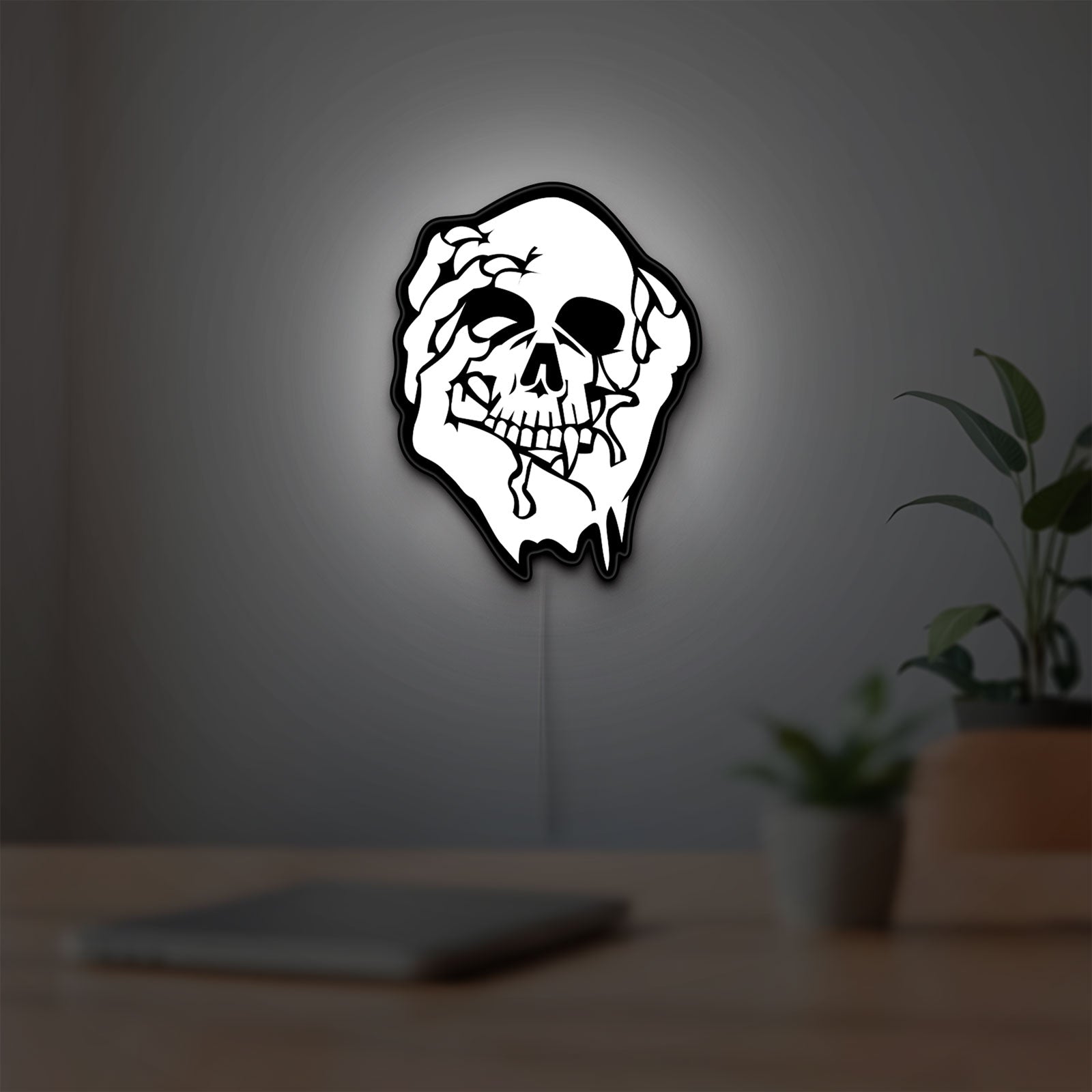 Skull LED lightbox hanging on a room wall with soft white light