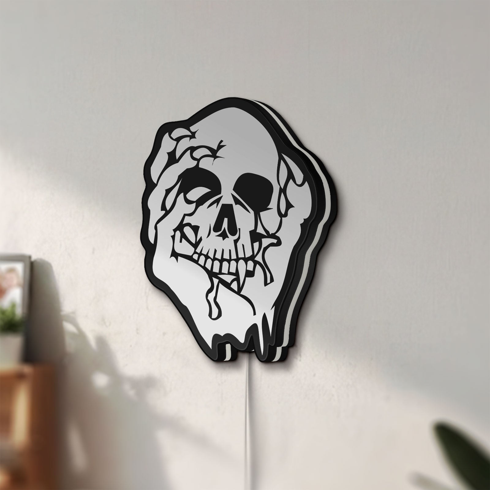 Unlit Skull LED lightbox mounted on a wall in daylight