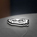 Skull LED lightbox lying flat on a desk with white glow
