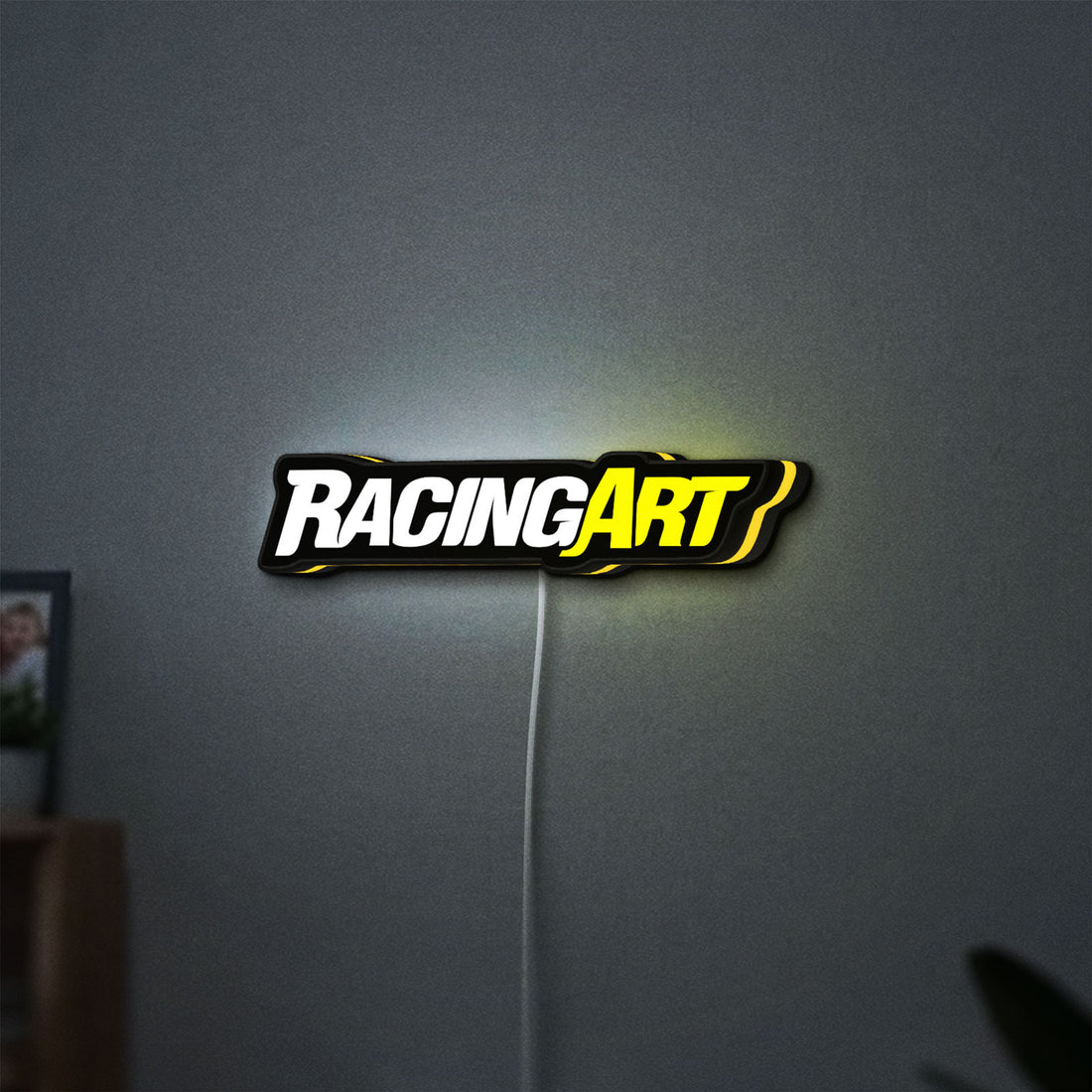 Racing Art LED lightbox hanging on a wall with yellow glow