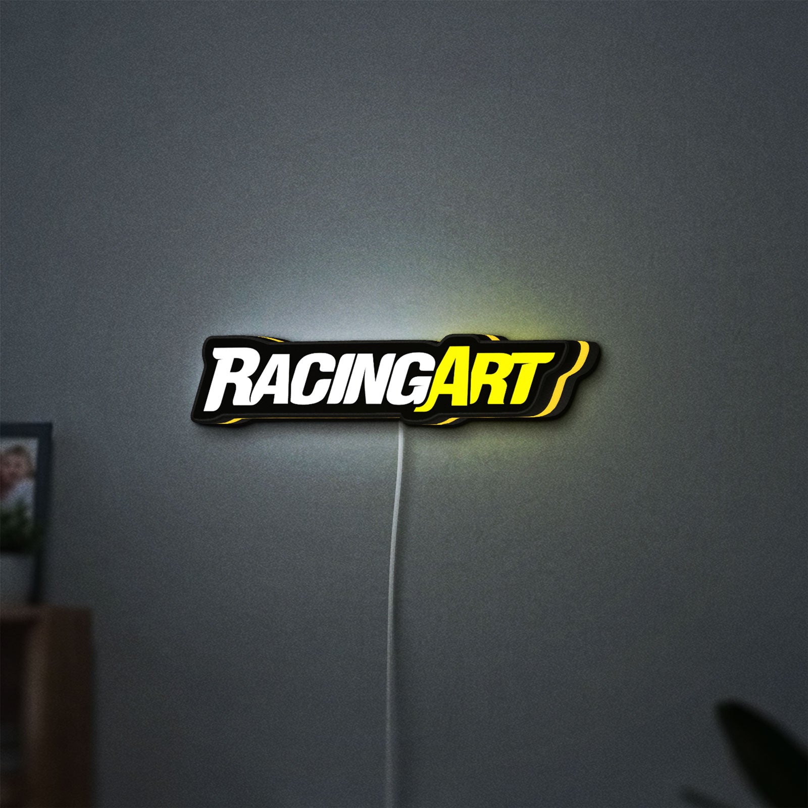Racing Art LED lightbox hanging on a wall with yellow glow