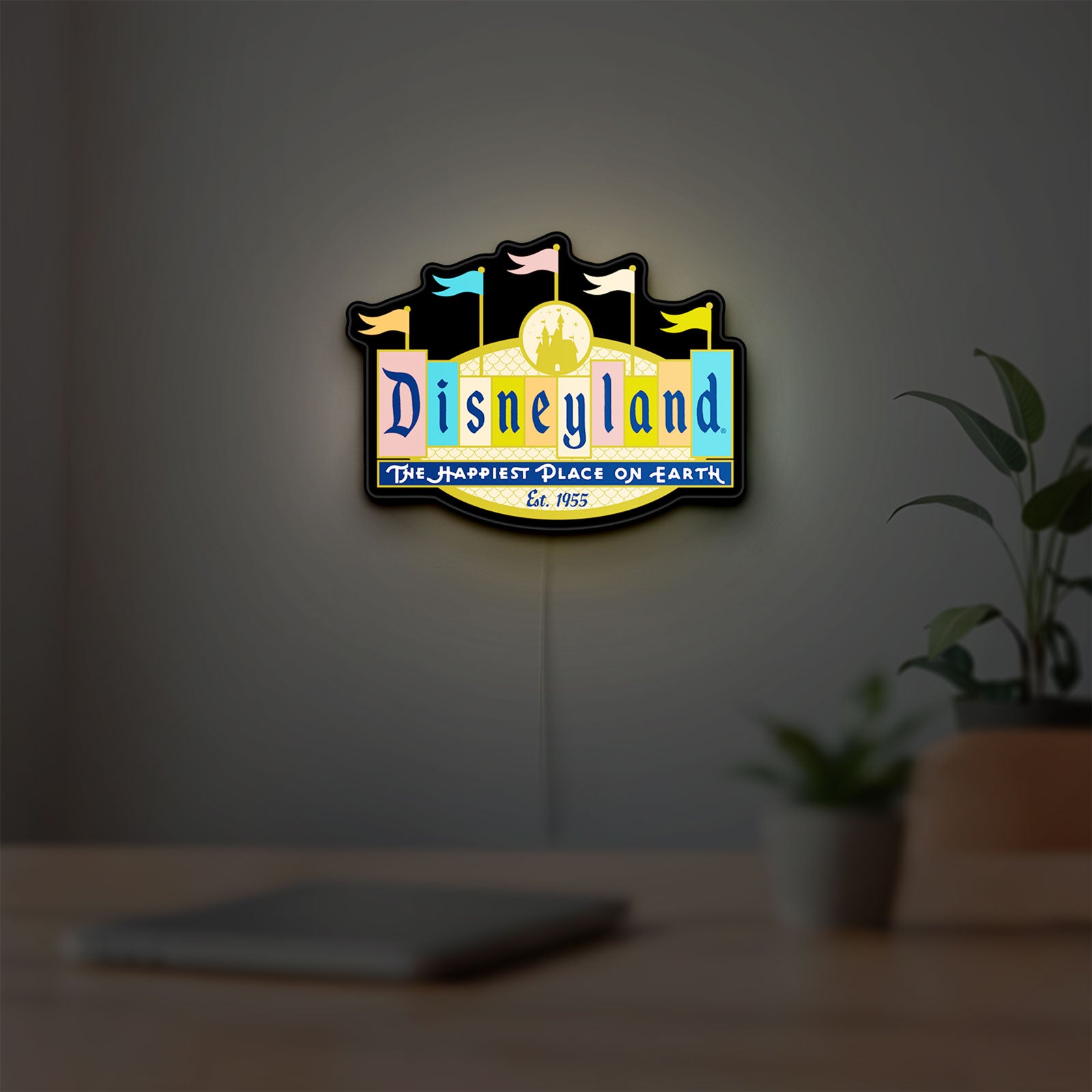 Disneyland Theme LED lightbox hanging on a room wall with soft yellow light