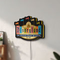 Unlit Disneyland Theme LED lightbox mounted on a wall in daylight