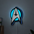 Star Trek Emblem LED lightbox hanging on a wall with blue glow